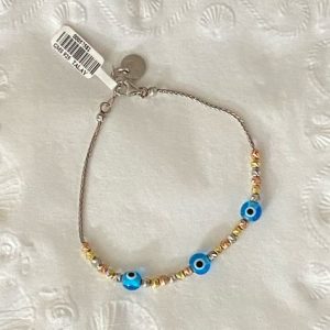 Adorned with a traditional evil eye charm, it offers symbolic protection and a charming accessory for babies.